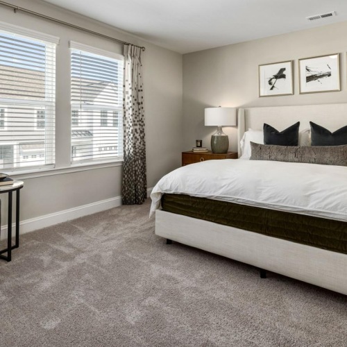 a bedroom with a bed and a chair