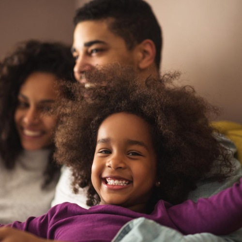 a family sitting on a couch