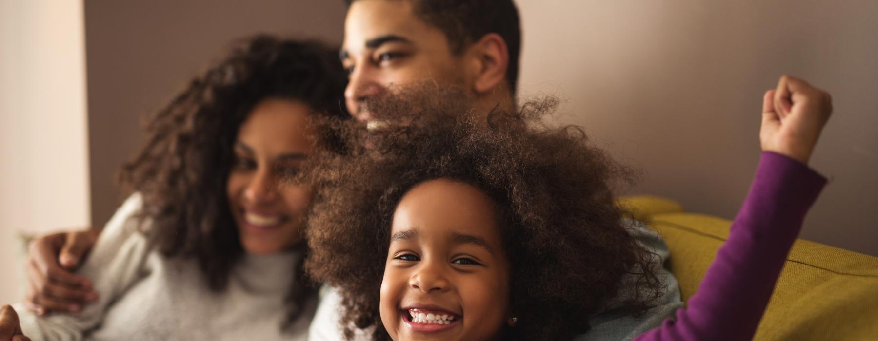 a family sitting on a couch